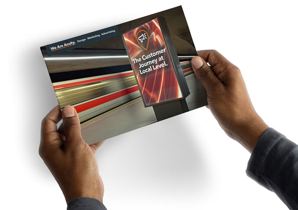 Hands holding a guide named The Customer Journey at Local Level