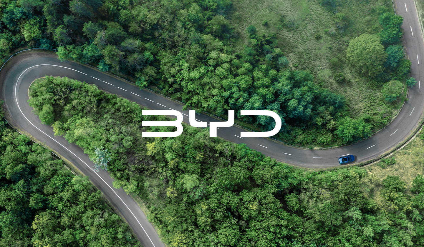 BYD logo over forest road